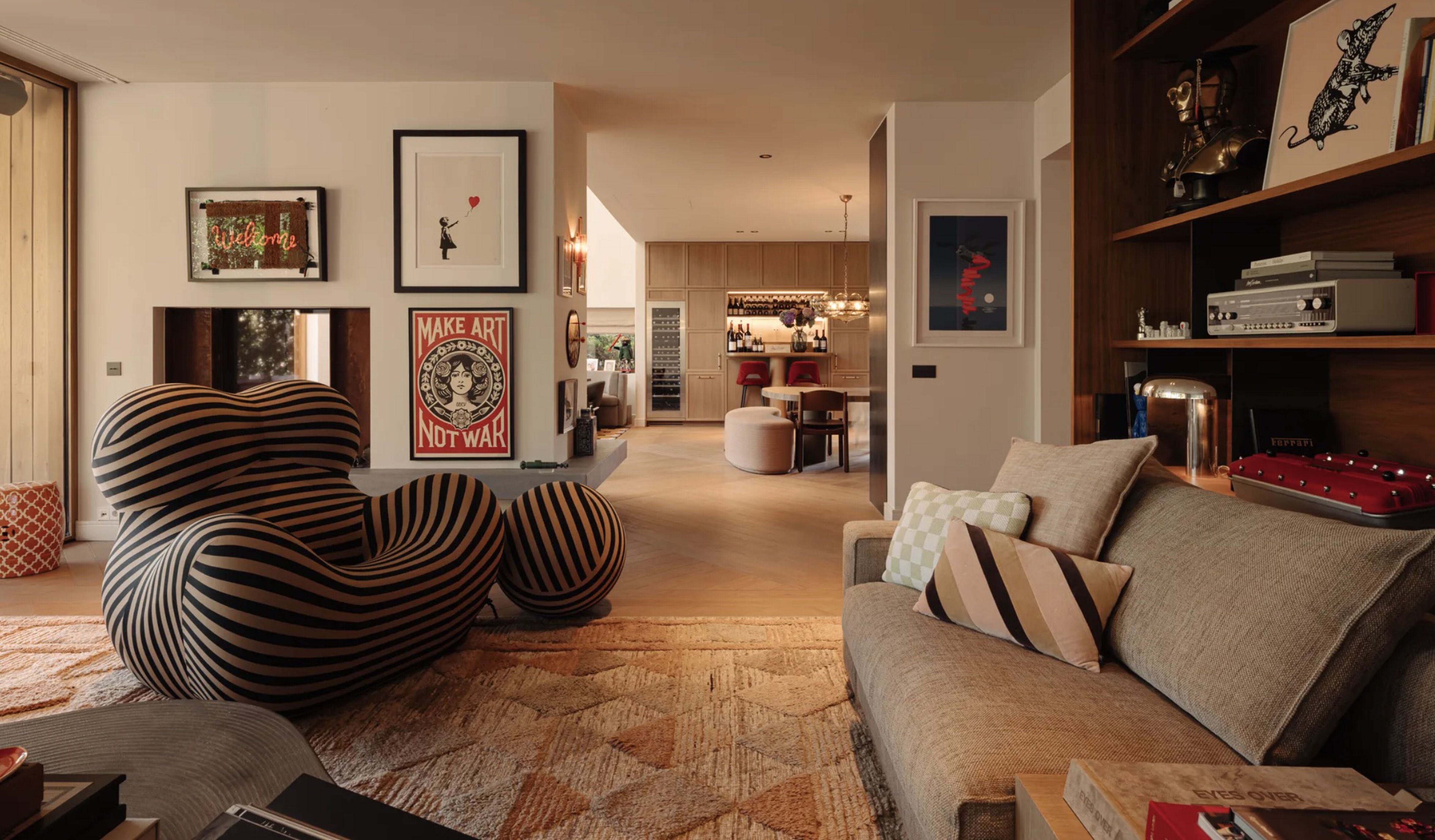 De woonkamer met de Banksy aan de muur van de villa in Amsterdam-Zuid