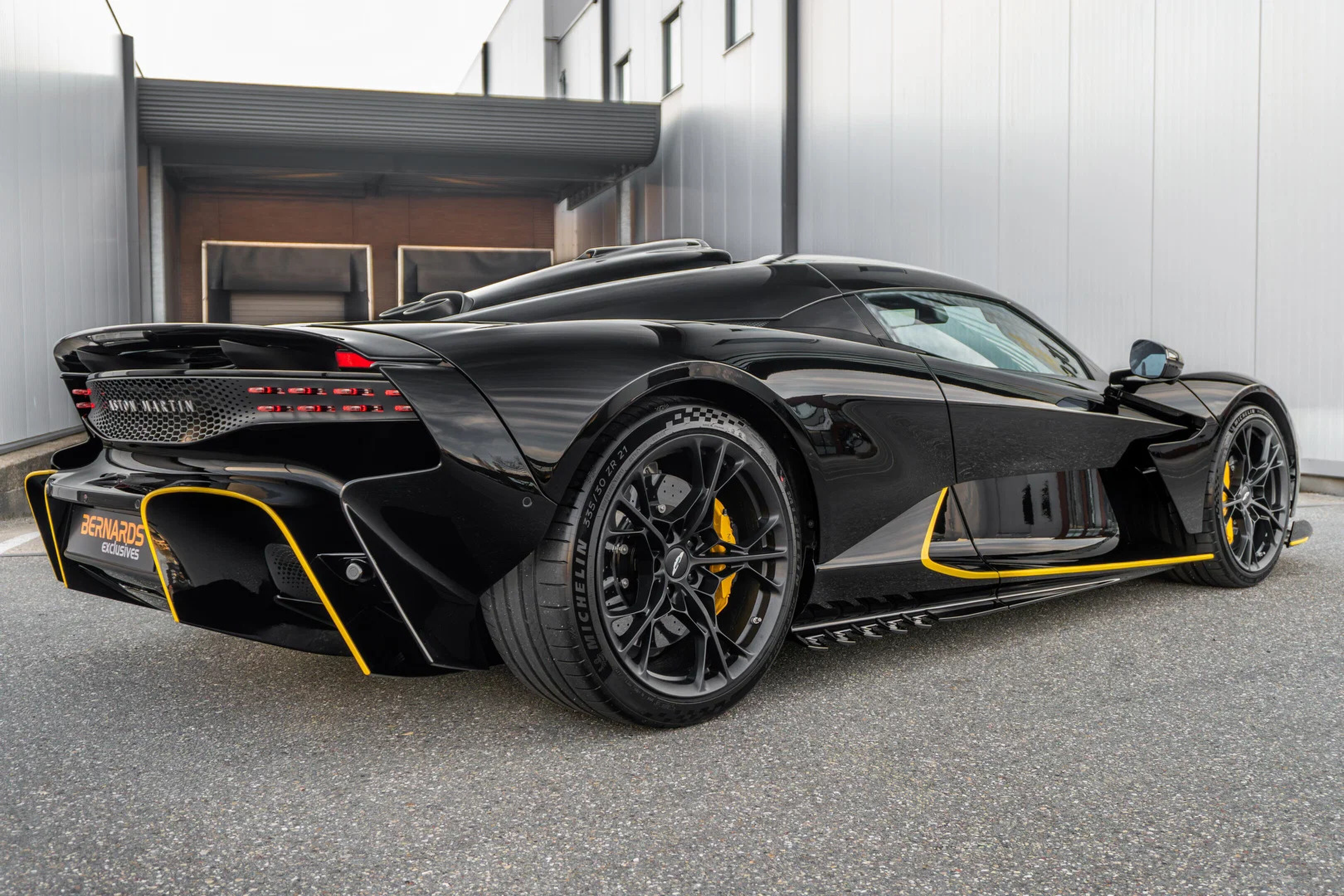 De achterzijde van de Aston Martin Valhalla in Jet Black met Ultra Yellow