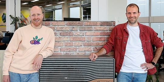 De broers Marijn en Bas Flipse van het bedrijf Quatt, poserend op een bank